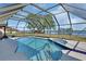 Enclosed pool area with views of the lake offering the perfect spot for relaxation and recreation with a jacuzzi and waterfall at 2075 Little Farms Ct, Deltona, FL 32738