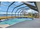 Inviting screened-in pool with beautiful lake views, perfect for relaxation and outdoor enjoyment at 2075 Little Farms Ct, Deltona, FL 32738