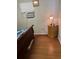 Bedroom with laminate wood flooring, simple furnishings, and an air conditioning unit by the window at 2201 S Peninsula Dr, Daytona Beach, FL 32118