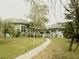 Light blue single story home with a walkway and lush landscaping at 2201 S Peninsula Dr, Daytona Beach, FL 32118