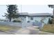 Side view of a light blue house with a low cinder block wall and driveway at 2201 S Peninsula Dr, Daytona Beach, FL 32118