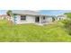 Spacious backyard with grassy area and patio at 24 Sea Gull Dr, Ormond Beach, FL 32176