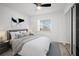Staged bedroom with large window, bed, and mirrored closet at 24 Sea Gull Dr, Ormond Beach, FL 32176