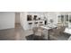 Contemporary dining area with stylish table setting, breakfast bar, and modern kitchen appliances, perfect for entertaining at 24 Sea Gull Dr, Ormond Beach, FL 32176