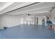 Spacious garage with epoxy floor, washer and dryer, utility sink, and extra storage space at 24 Sea Gull Dr, Ormond Beach, FL 32176