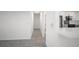 Hallway features wood-look tile flooring and a view into the renovated kitchen at 24 Sea Gull Dr, Ormond Beach, FL 32176