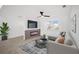 Comfortable living room featuring a modern fireplace, ceiling fan, and neutral decor with a contemporary sofa and area rug at 24 Sea Gull Dr, Ormond Beach, FL 32176