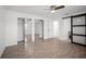 This primary bedroom features wood-look tile flooring, ceiling fan, and double mirrored closets at 24 Sea Gull Dr, Ormond Beach, FL 32176