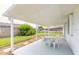 Covered patio with table and chairs, perfect for outdoor dining at 24 Sea Gull Dr, Ormond Beach, FL 32176