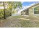 Backyard with screened patio, fence, and mature trees at 242 W Fiesta Key Loop, Deland, FL 32720
