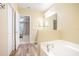 Bathroom with garden tub and access to bedroom at 242 W Fiesta Key Loop, Deland, FL 32720