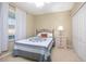Cozy bedroom with a double bed, nightstand, and window coverings at 242 W Fiesta Key Loop, Deland, FL 32720
