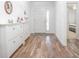Bright entryway with white storage cabinets and wood-look flooring at 242 W Fiesta Key Loop, Deland, FL 32720