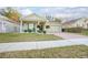 House exterior featuring a two-car garage and well-manicured lawn at 242 W Fiesta Key Loop, Deland, FL 32720
