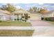 House exterior featuring a two-car garage and well-manicured lawn at 242 W Fiesta Key Loop, Deland, FL 32720