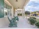 Relaxing front porch with green rocking chairs and landscaping at 242 W Fiesta Key Loop, Deland, FL 32720