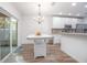 Bright kitchen with white cabinets, tile backsplash, and breakfast bar at 242 W Fiesta Key Loop, Deland, FL 32720