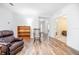Living room with hardwood floors, a rocking chair, and access to other rooms at 242 W Fiesta Key Loop, Deland, FL 32720