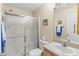 Bathroom with frosted shower doors, light walls, sink, and mirror at 2610 Hialeah Ave, The Villages, FL 32162