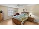 Cozy bedroom featuring a ceiling fan, light-colored walls, and a comfortable bed with stylish bedding at 2610 Hialeah Ave, The Villages, FL 32162