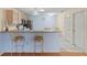 Kitchen with counter seating, tile floors, and blue walls at 2610 Hialeah Ave, The Villages, FL 32162