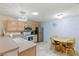 Cozy kitchen with warm-toned cabinets, stainless steel appliances, and a breakfast nook at 2610 Hialeah Ave, The Villages, FL 32162