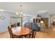 Open concept living and dining area with wood floors and sliding door access to the lanai at 2610 Hialeah Ave, The Villages, FL 32162