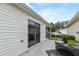 Back patio with grill and sliding glass door entrance to home at 2610 Hialeah Ave, The Villages, FL 32162