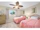 Inviting bedroom with two twin beds, ceiling fan, and a bright window with neutral colored walls at 2711 N Halifax Ave # 184, Daytona Beach, FL 32118