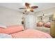 Comfortable bedroom featuring two twin beds, mirrored closet, and ceiling fan at 2711 N Halifax Ave # 184, Daytona Beach, FL 32118