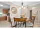 Bright dining area featuring a modern chandelier, neutral walls, and tile flooring at 2711 N Halifax Ave # 184, Daytona Beach, FL 32118