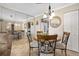 Bright dining area showcasing mirrored wall, chandelier, and seating for four at 2711 N Halifax Ave # 184, Daytona Beach, FL 32118