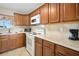 Well-lit kitchen featuring stainless steel appliances, tile backsplash, and ample cabinet space at 2711 N Halifax Ave # 184, Daytona Beach, FL 32118