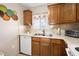 Efficient kitchen featuring wood cabinetry, tile backsplash, and modern appliances at 2711 N Halifax Ave # 184, Daytona Beach, FL 32118