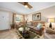 Cozy living room showcasing a comfortable sofa, ceiling fan, and natural light at 2711 N Halifax Ave # 184, Daytona Beach, FL 32118