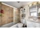 Well-maintained bathroom featuring a tub with shower, sliding glass door, and vanity with storage at 2711 N Halifax Ave # 463, Daytona Beach, FL 32118