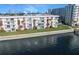 Waterfront condo building with lush landscaping, dock, and city skyline views at 2711 N Halifax Ave # 463, Daytona Beach, FL 32118