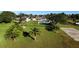 Large grassy backyard with palm trees and a home in the background at 2728 S Peninsula, Daytona Beach, FL 32118