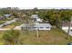 Aerial view of a cozy home surrounded by lush greenery in a peaceful neighborhood at 303 Warwick Ave, Ormond Beach, FL 32174