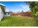 Large grassy backyard with a wood fence, offering ample space for outdoor activities at 303 Warwick Ave, Ormond Beach, FL 32174