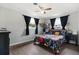 Comfortable bedroom with hardwood floors, two windows, and a ceiling fan at 303 Warwick Ave, Ormond Beach, FL 32174