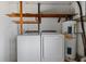 Laundry area features modern washer and dryer with a utility water heater and shelf space at 303 Warwick Ave, Ormond Beach, FL 32174