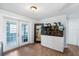 Spacious living room with wood floors, white trim, and sliding glass doors to the backyard at 303 Warwick Ave, Ormond Beach, FL 32174
