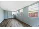 Bright and airy sunroom with three windows and wood-look floors at 303 Warwick Ave, Ormond Beach, FL 32174