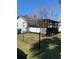 Home's side yard with screened porch and chain link fence at 309 N Boston Ave, Deland, FL 32724