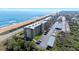 A high angle aerial view of condos next to the beach with covered parking spaces at 3180 Ocean Shore Blvd # 309, Ormond Beach, FL 32176