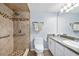 Bathroom features a tiled shower, handrails, modern fixtures, and a vanity with good counter space at 3180 Ocean Shore Blvd # 309, Ormond Beach, FL 32176