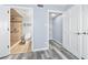 Bathroom with a beautifully tiled shower and an adjacent closet with shelving for efficient storage at 3180 Ocean Shore Blvd # 309, Ormond Beach, FL 32176