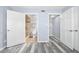 Bathroom with walk-in shower and wood-look plank flooring with an open closet at 3180 Ocean Shore Blvd # 309, Ormond Beach, FL 32176
