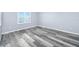 Comfortable bedroom with plank floors, light blue walls, and a window that lets in plenty of natural light at 3180 Ocean Shore Blvd # 309, Ormond Beach, FL 32176